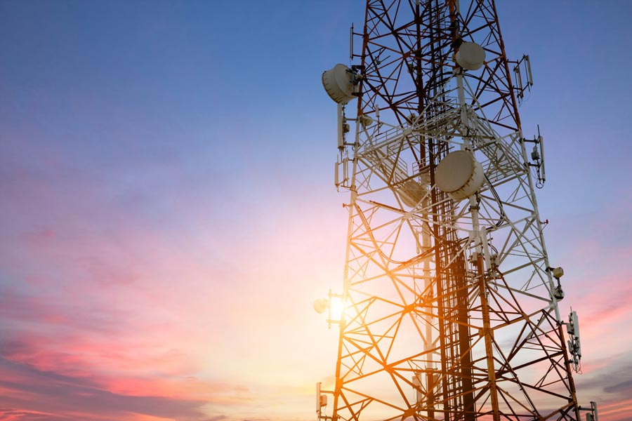 a satelite tower pictured in a sunset scene