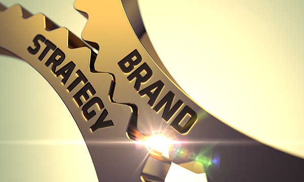 two gears with text written on them reading "brand strategy"