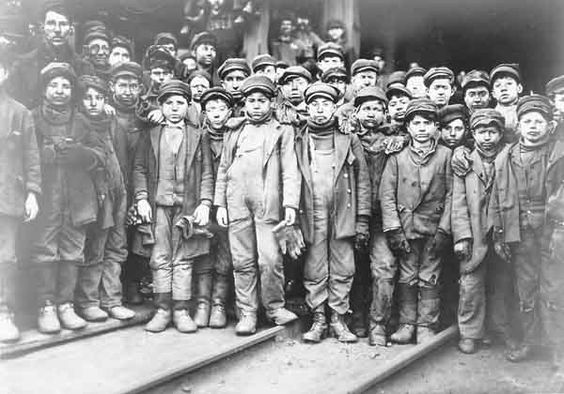 a black and white picture of a group of child labourers